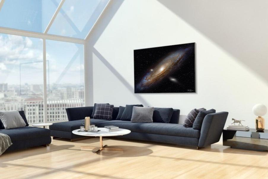 A wall art mockup featuring the deep sky photograph titled "One Trillion Stars" by astrophotographer J K Lovelace on display in an upscale loft apartment as a metal print.